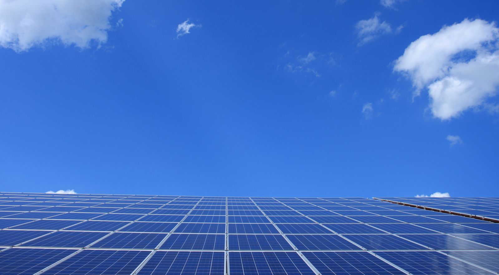 Solar panels angled toward a blue sky